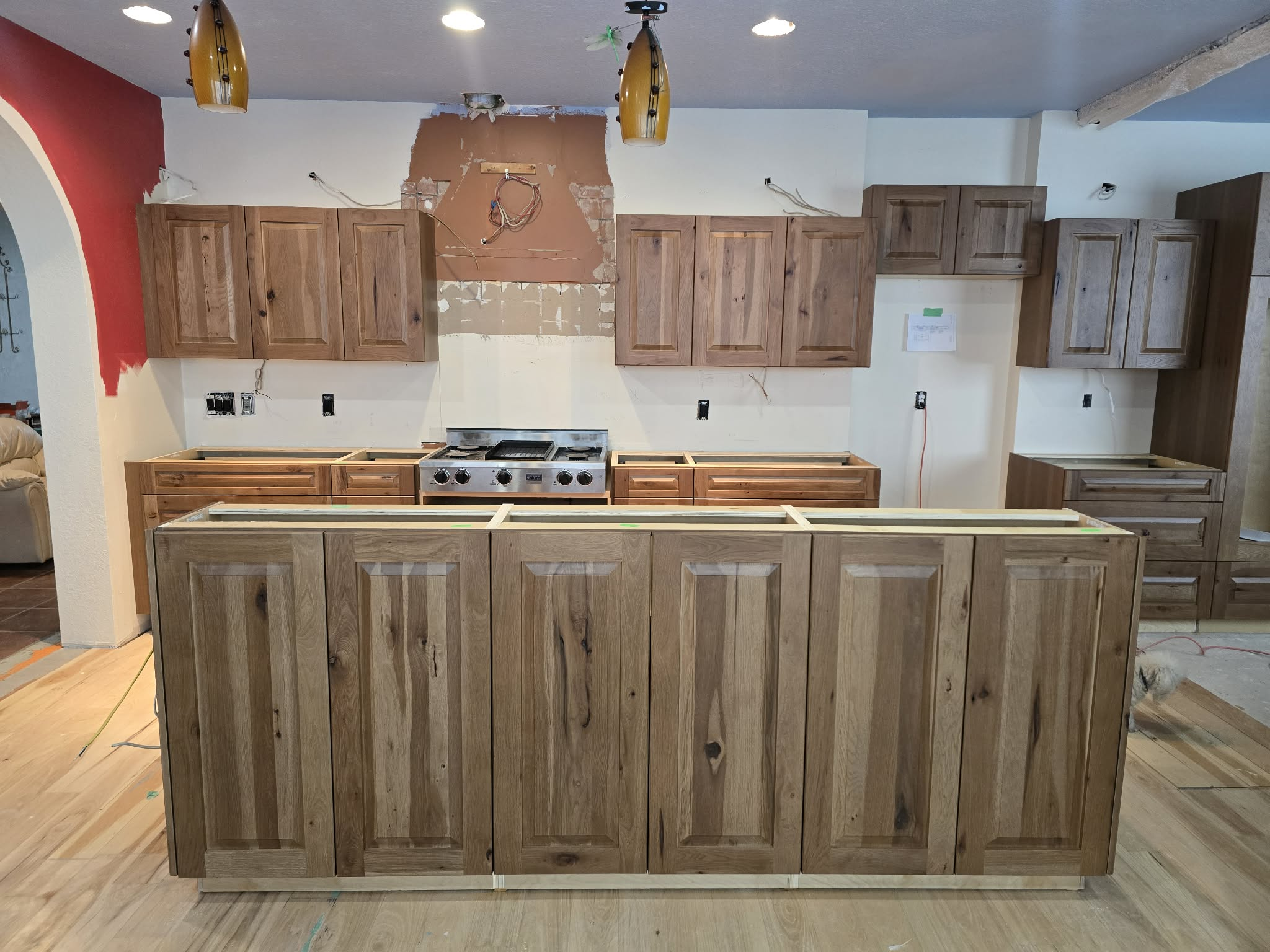 Completed kitchen renovation with custom cabinets and warm wood finishes
