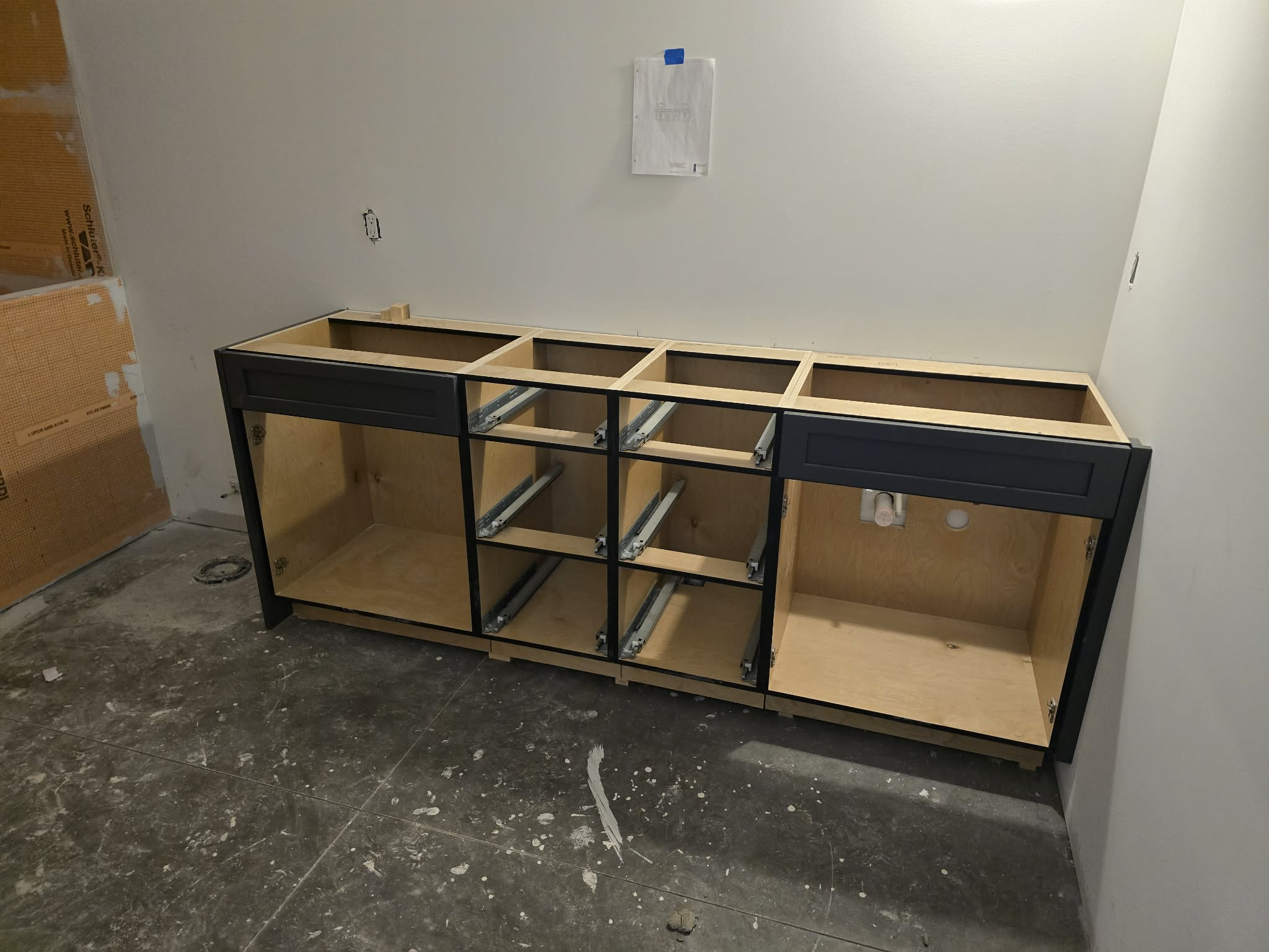 Kitchen cabinet installation project with base cabinets in place