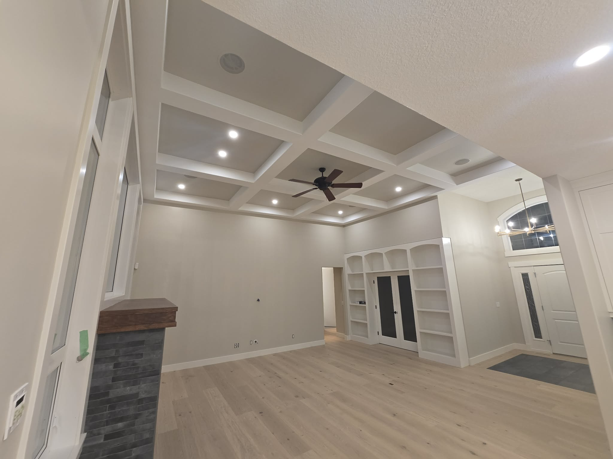 Open-concept room with new flooring and finished trim work