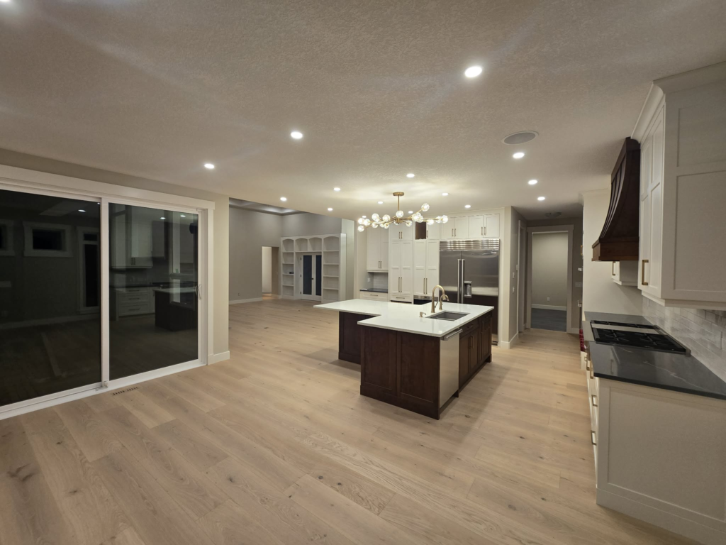 White kitchen cabinetry, dark island and coordinated interior finish