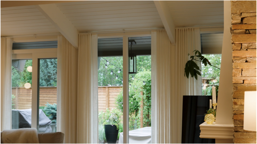 Fresh white-painted ceiling and trim beside a natural stone fireplace wall