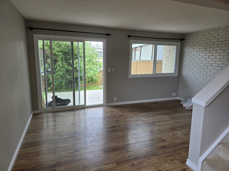 Living room with the replacement balcony door, window, painted walls and repainted frames