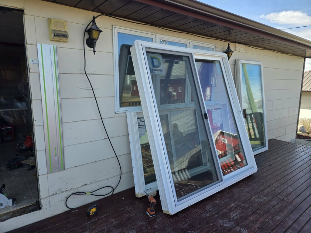 Replacement window and door units staged on the balcony