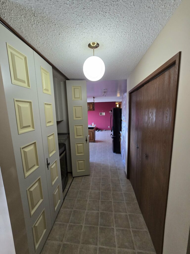 Corridor and doors leading to the kitchen during renovation preparation