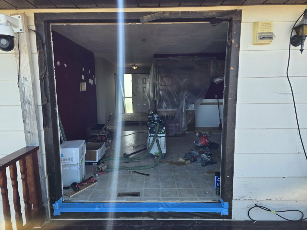 Balcony-door opening during replacement with tools and interior protection visible