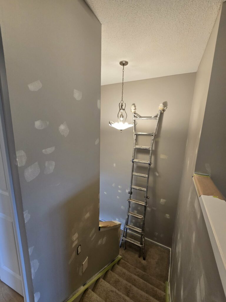 Tall stairwell with wall repairs, protection and access equipment