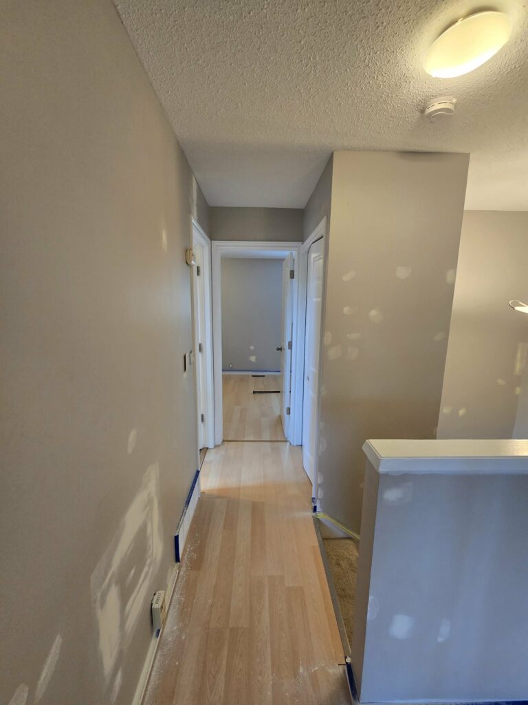 Upstairs hall with repaired wall areas before painting