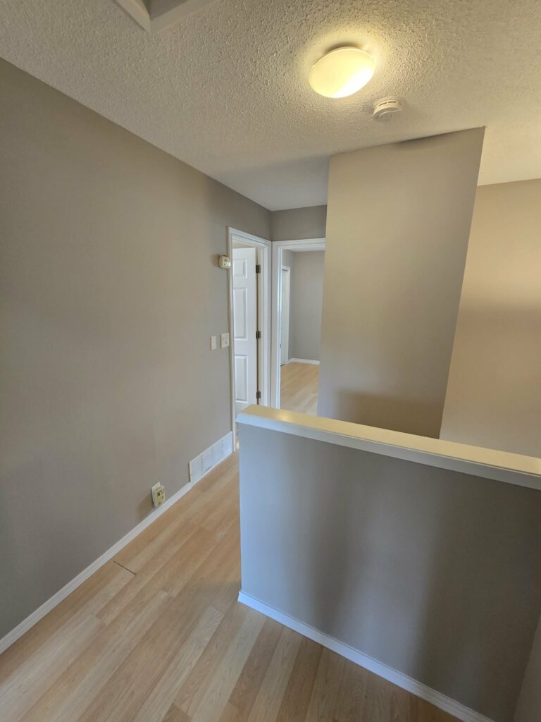 Upstairs landing with a smooth wall finish and refreshed white trim