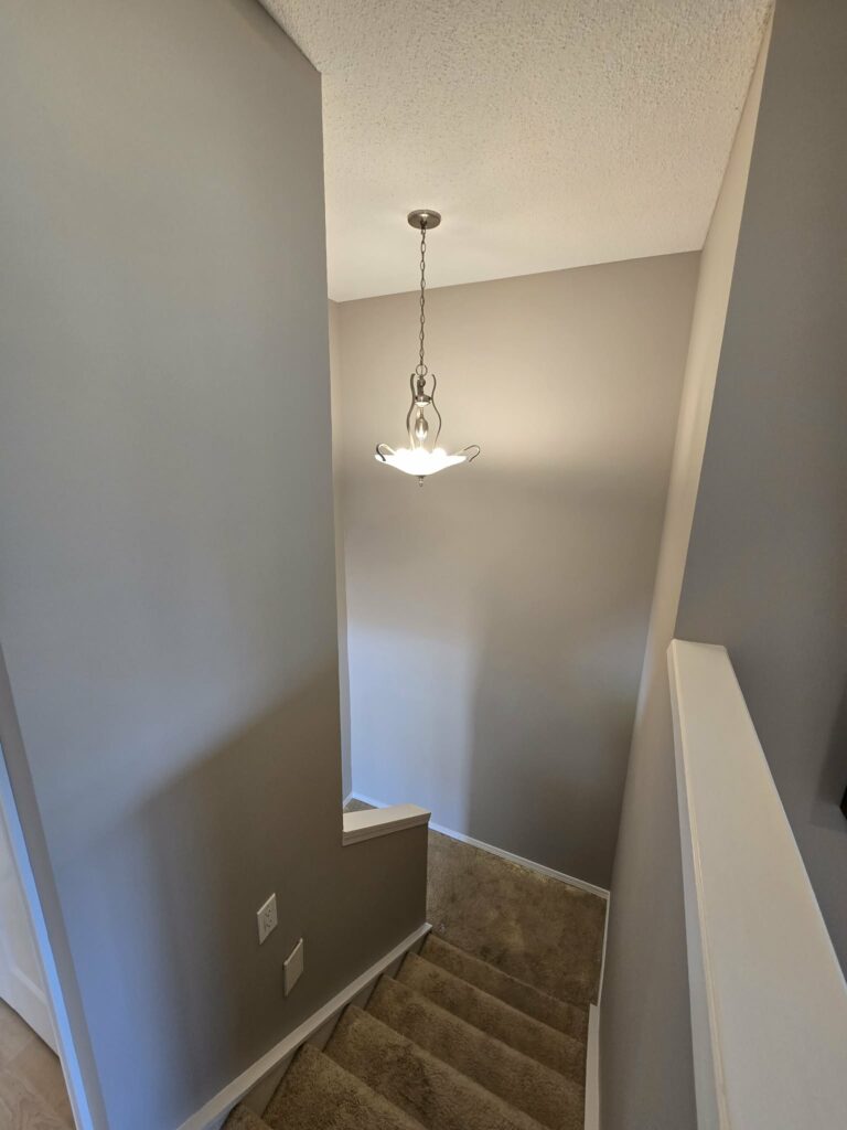 Stairwell after the repaired walls and trim were painted