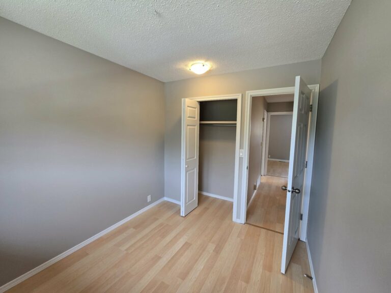 Finished bedroom with repainted walls, doors and closet frames