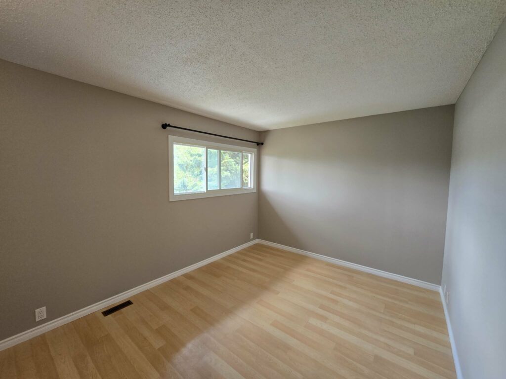 Finished bedroom with a replacement window and refreshed frame