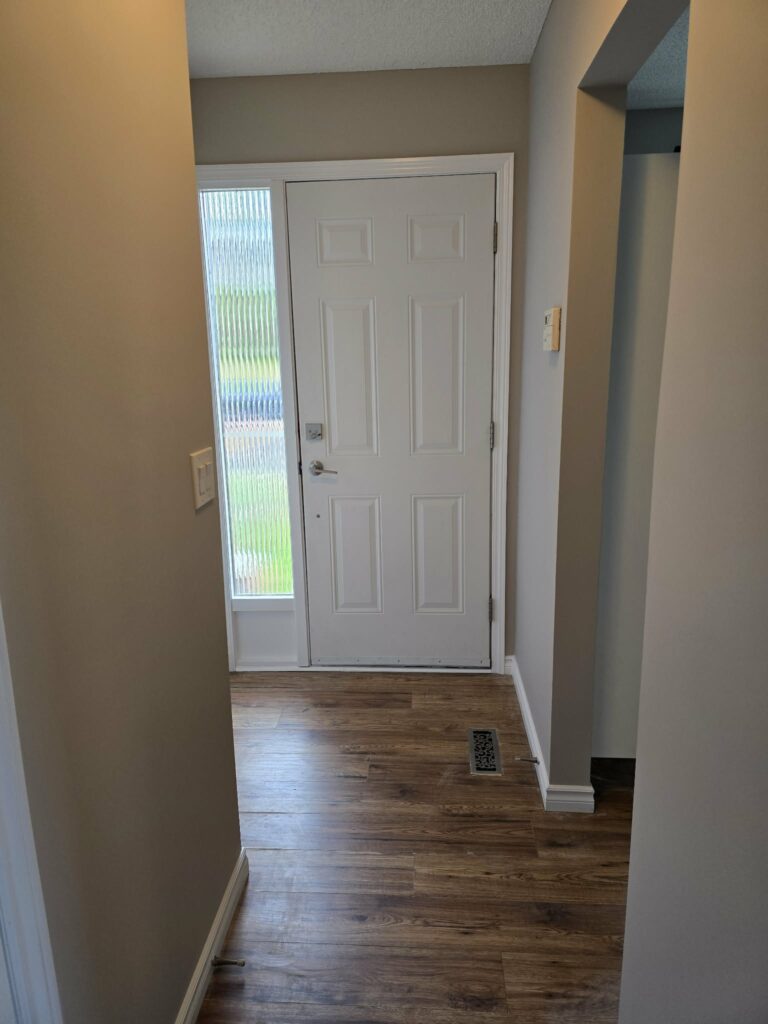Entry area with repainted door frame and surrounding walls