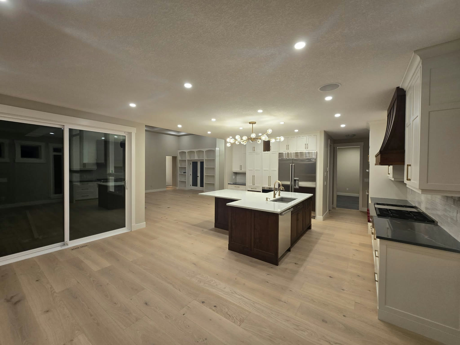 White kitchen cabinetry with a wood island and light flooring